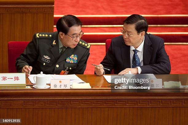 Xu Caihou, vice chairman of China's Central Military Commission, left, speaks with Zhang Dejiang, vice premier of China, at a plenary session on the...