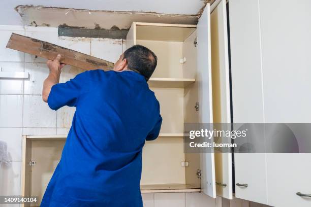 joiner removes kitchen cabinet because of a leak - shelf strip stock pictures, royalty-free photos & images