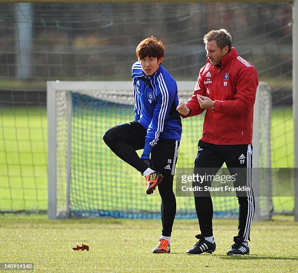 Thorsten Fink, head coach of Hamburger SV talks with Heung Min Son during a training session of Hamburger SV on March 8, 2012 in Hamburg, Germany.