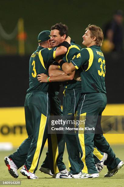 Australian players celebrate with Clint McKay after the third One Day International Final series match between Australia and Sri Lanka at Adelaide...