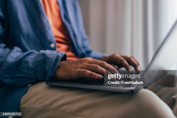 an unrecognizable casually dressed programmer working from home on his computer - copy writing stock pictures, royalty-free photos & images