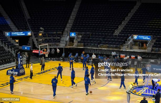 The Warriors warm up before the Golden State Warriors played the Denver Nuggets in their first preseason game at Chase Arena in San Francisco,...