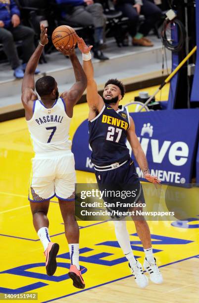 Eric Paschall shoots defended by Jamal Murray during the first half as the Golden State Warriors played the Denver Nuggets in their first preseason...