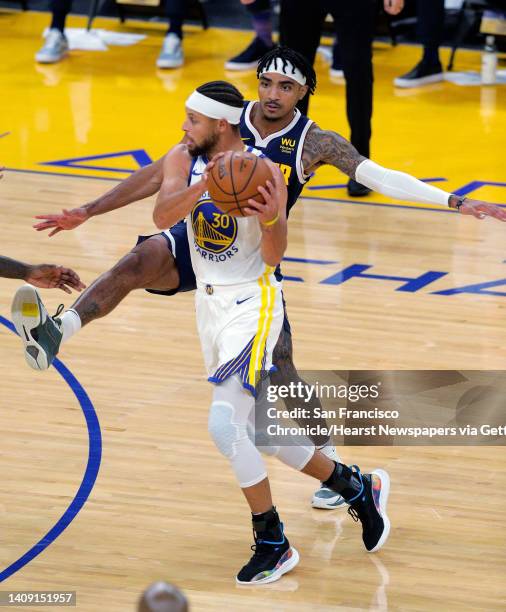 Stephen Curry dribbles by Gary Harris during the first half as the Golden State Warriors played the Denver Nuggets in their first preseason game at...