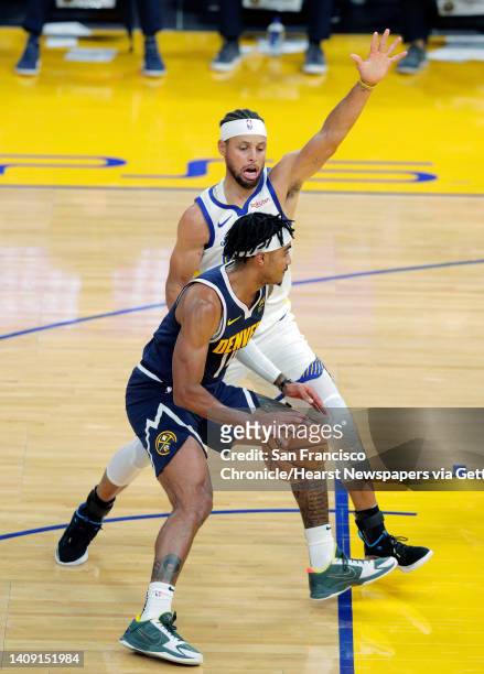 Stephen Curry defends against Gary Harris during the first half as the Golden State Warriors played the Denver Nuggets in their first preseason game...