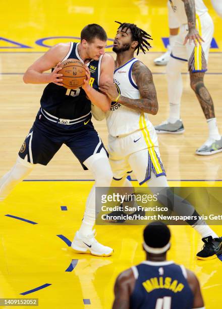 Marquese Chriss defends against Nikola Jokic during the first half as the Golden State Warriors played the Denver Nuggets in their first preseason...