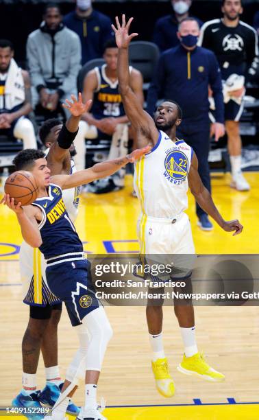 Andrew Wiggins defends against Michael Porter Jr., during the first half as the Golden State Warriors played the Denver Nuggets in their first...