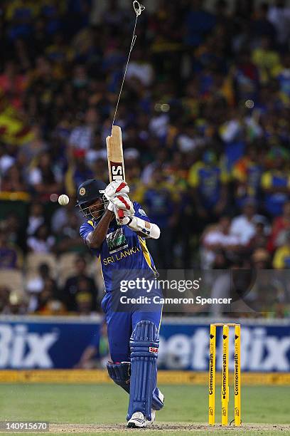 Farveez Maharoof of Sri Lanka breaks his bat as he plays a shot during the third One Day International Final series match between Australia and Sri...