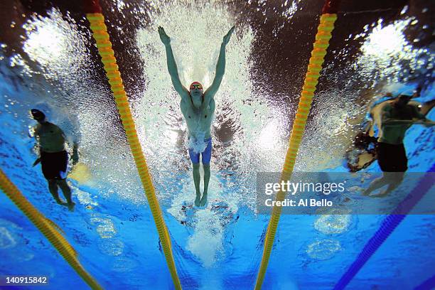 Francois Heersbrandt of Belguim, Konrad Czerniak of Poland , and Rafael Munoz of Spain race in the the Mens 100m Butterfly heats during day six of...