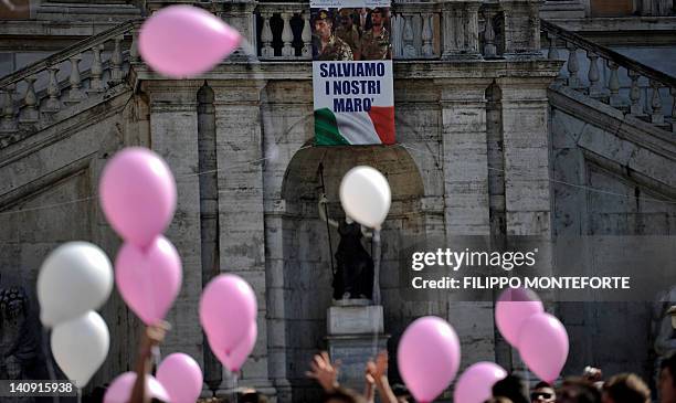 Placard reading "Save our marines" is hanged on Rome's city hall, the Campidoglio, as members of the Italian far-right party "La destra" demonstrate...