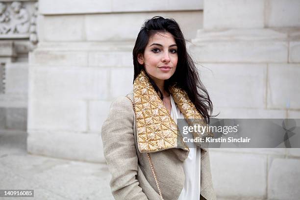 Anna Nooshin, executive editor of nsmbl wearing Dennis thm jacket, brooms bazaar top at Paris Fashion Week Autumn/Winter 2012 womenswear shows on...