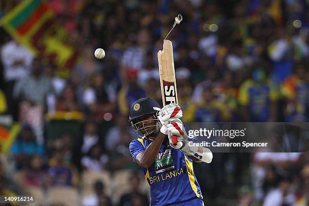 Farveez Maharoof of Sri Lanka breaks his bat as he plays a shot during the third One Day International Final series match between Australia and Sri...