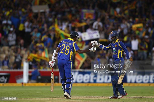 Farveez Maharoof of Sri Lanka and team mate Upul Tharanga celeabrate during their partnership during the third One Day International Final series...