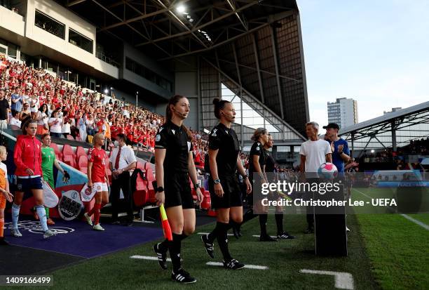 Referee Rebecca Welch with assistants Sian Massey and Lisa Rashid walk onto the pitch prior to kick off of the UEFA Women's Euro 2022 group B match...