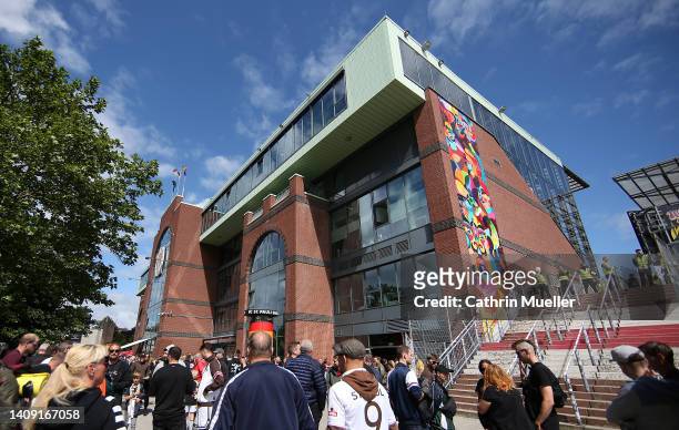 Fans arrive to the stadium prior to the Second Bundesliga match between FC St. Pauli and 1. FC Nürnberg at Millerntor Stadium on July 16, 2022 in...