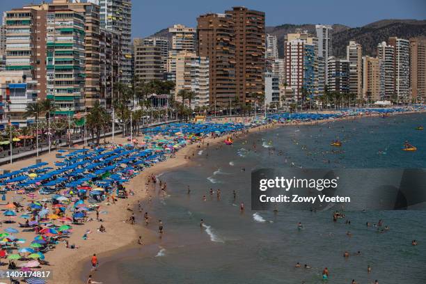 Tourists fill the Levante beach in Benidorm to quench high temperatures as a heatwave sweeps across Spain on July 16, 2022 in Benidorm, Spain.