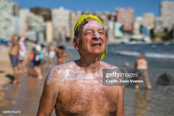 Jose Luis, a tourist from Madrid who is spending a few months in Benidorm, strolls along the Levante beach while covered with sunscreen to avoid...