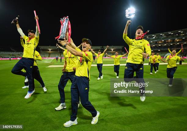 Nathan Ellis of Hampshire Hawks celebrates alongside their teams with the Vitality Blast Trophy following the Vitality Blast Final match between...