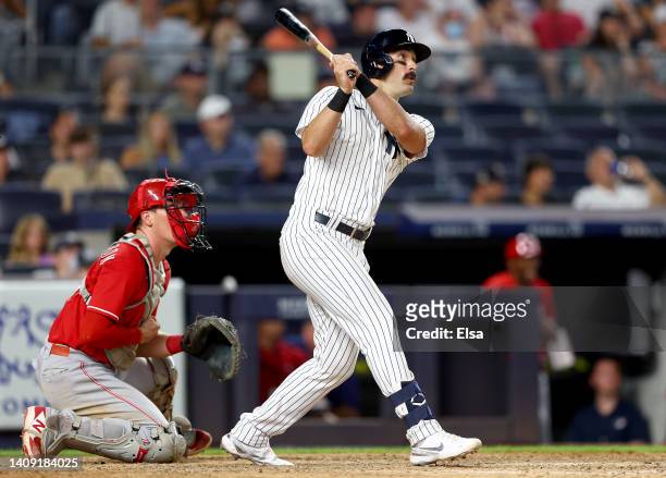 Matt Carpenter of the New York Yankees hits a two run home run as Tyler Stephenson of the Cincinnati Reds defends at Yankee Stadium on July 14, 2022...
