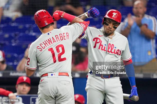 Kyle Schwarber of the Philadelphia Phillies celebrates with Johan Carmago after hitting a homerun in the eighth inning against the Miami Marlins at...