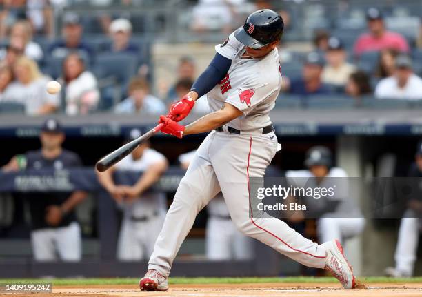 Rafael Devers of the Boston Red Sox hits a solo home run in the first inning against the New York Yankees at Yankee Stadium on July 16, 2022 in the...