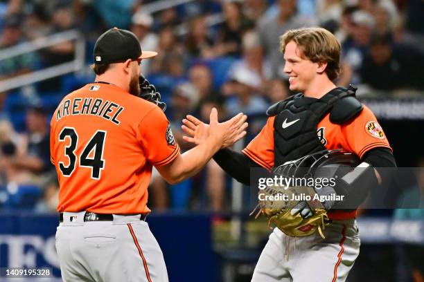 Joey Krehbiel celebrates with Adley Rutschman of the Baltimore Orioles after defeating the Tampa Bay Rays 6-4 in eleven innings at Tropicana Field on...