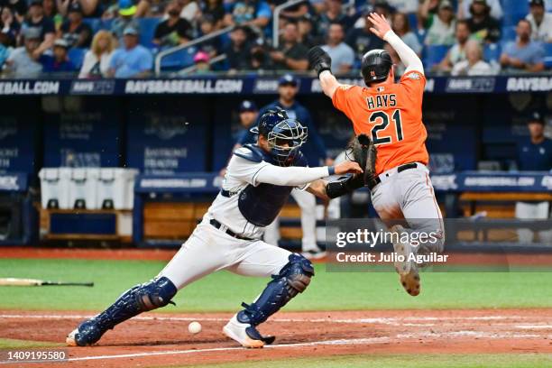 Christian Bethancourt of the Tampa Bay Rays drops the ball before making the tag on Austin Hays of the Baltimore Orioles in the tenth inning at...