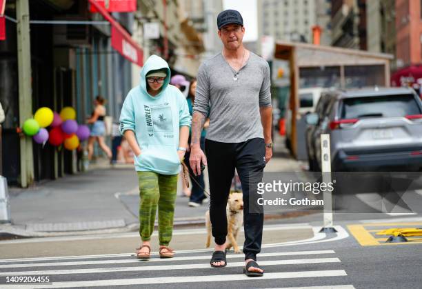 Dylan McDermott walks with Charlotte Rose McDermott and dog Otis on July 16, 2022 in New York City.