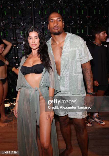 Nicole Williams English and Larry English pose backstage for Sports Illustrated Swimsuit Runway Show During Paraiso Miami Beach on July 16, 2022 in...