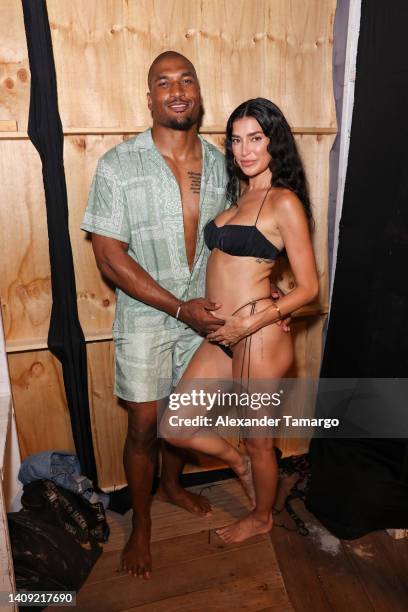 Larry English and Nicole Williams English pose backstage for Sports Illustrated Swimsuit Runway Show During Paraiso Miami Beach on July 16, 2022 in...