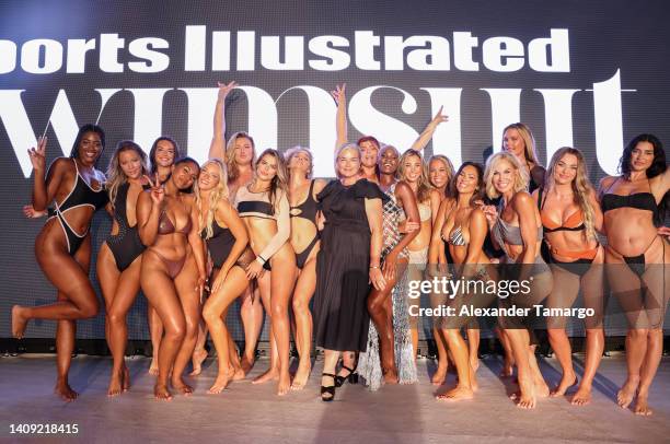 Day poses with models on the runway during Sports Illustrated Swimsuit Runway Show During Paraiso Miami Beach on July 16, 2022 in Miami Beach,...