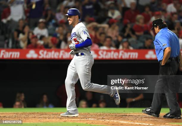 Freddie Freeman the Los Angeles Dodgers crosses home plate after hitting a homerun recording his 1000th career RBI in the 5th inning against the Los...