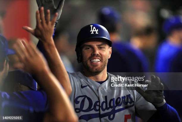 Freddie Freeman the Los Angeles Dodgers celebrates in the dugout after hitting a homerun recording his 1000th career RBI in the 5th inning against...