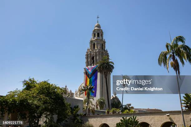 Large Pride flag hangs from the Museum of Us at 2022 San Diego Pride Parade on July 16, 2022 in San Diego, California.