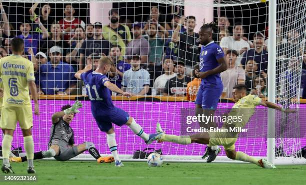 Timo Werner of Chelsea scores a goal against goaltender Óscar Jiménez and Sebastián Cáceres of Club América as Michy Batshuayi of Chelsea looks on...