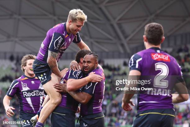 The Storm celebrate after Nick Meaney of the Storm scores a try during the round 18 NRL match between the Melbourne Storm and the Canberra Raiders at...