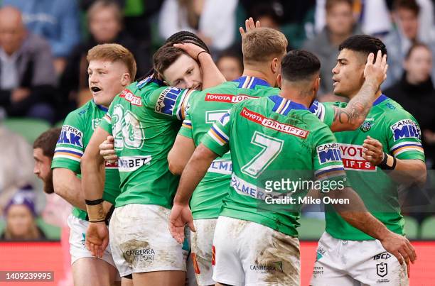 James Schiller of the Raiders celebrates with teammates after scoring a try during the round 18 NRL match between the Melbourne Storm and the...