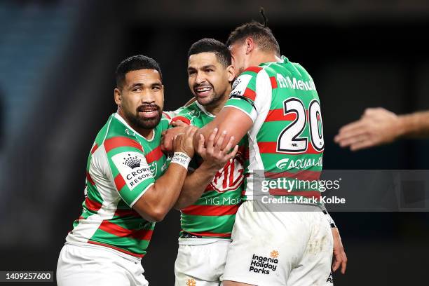 Cody Walker of the Rabbitohs celebrates with his team mates Siliva Havili and Davvy Moale of the Rabbitohs after scoring a tryduring the round 18 NRL...