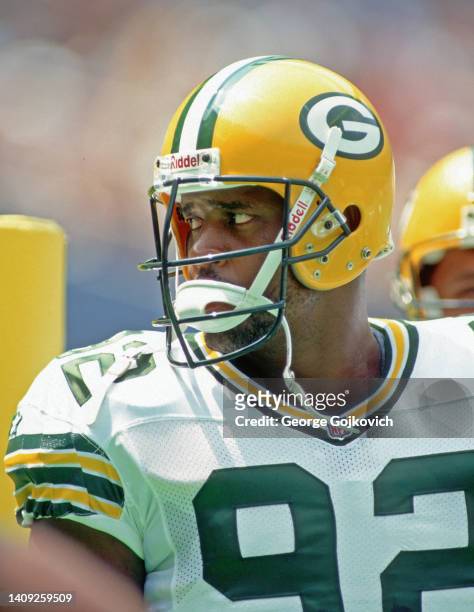 Defensive lineman Reggie White of the Green Bay Packers looks on from the sideline during a preseason game against the Pittsburgh Steelers at Three...