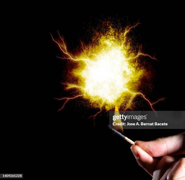 a man's hand with a match that causes an explosion with smoke. - finger blaster 個照片及圖片檔