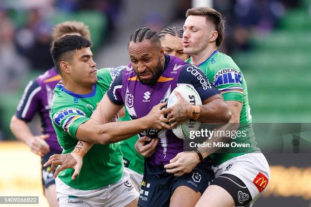 Justin Olam of the Storm is tackled during the round 18 NRL match between the Melbourne Storm and the Canberra Raiders at AAMI Park, on July 17 in...