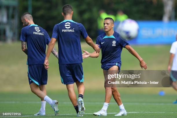 Alexis Sanchez gives five to Valentin Carboni of FC Internazionale during the FC Internazionale training session at the club's training ground Suning...