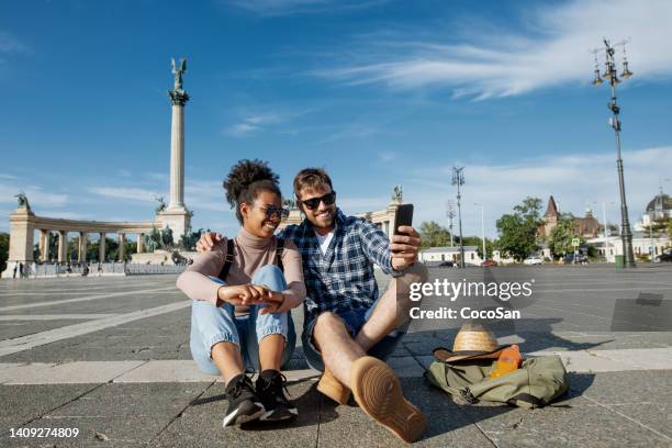 multi ethnic couple on city break in summer. couple visiting budapest, hungary - hungary summer stock pictures, royalty-free photos & images