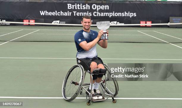 Joachim Gerard of Belgium poses with the British Open mens singles trophy after beating Martin De La Puente of Spain during day six of the British...