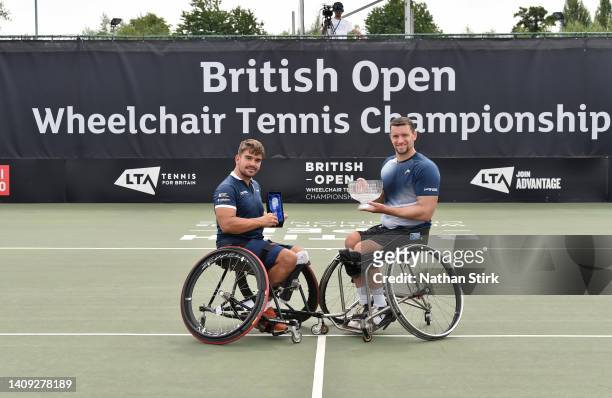 Joachim Gerard of Belgium poses with the British Open mens singles trophy after beating Martin De La Puente (L of Spain during day six of the British...