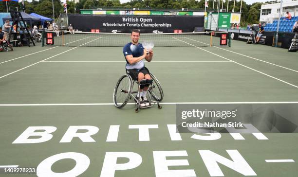 Joachim Gerard of Belgium poses with the British Open mens singles trophy after beating Martin De La Puente of Spain during day six of the British...