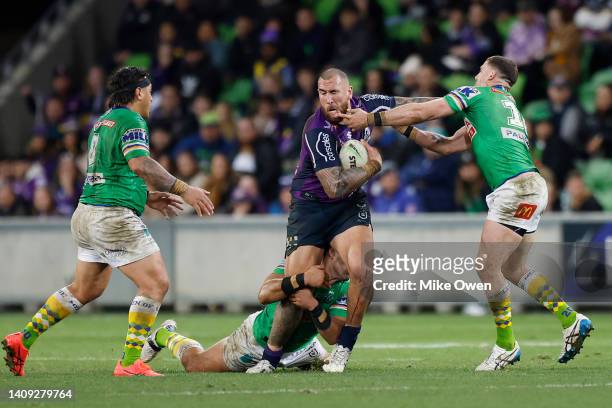 Nelson Asofa-Solomona of the Storm is tackled during the round 18 NRL match between the Melbourne Storm and the Canberra Raiders at AAMI Park, on...
