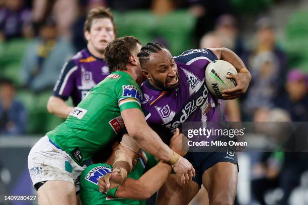 Justin Olam of the Storm is tackled during the round 18 NRL match between the Melbourne Storm and the Canberra Raiders at AAMI Park, on July 17 in...