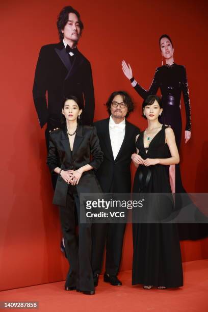 Actress/singer Cya Liu, actor Gordon Lam Ka-tung and actress Fish Liew pose on the red carpet of the 40th Hong Kong Film Awards on July 17, 2022 in...