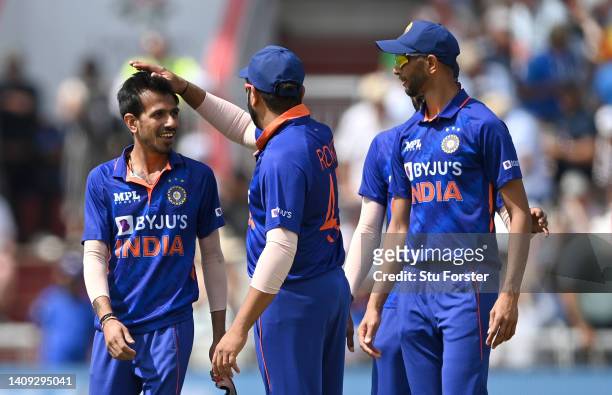 India captain Rohit Sharma congratulates bowler Yuzvendra Chahal after he had bowled England batsman Reece Topley during the 3rd Royal London Series...